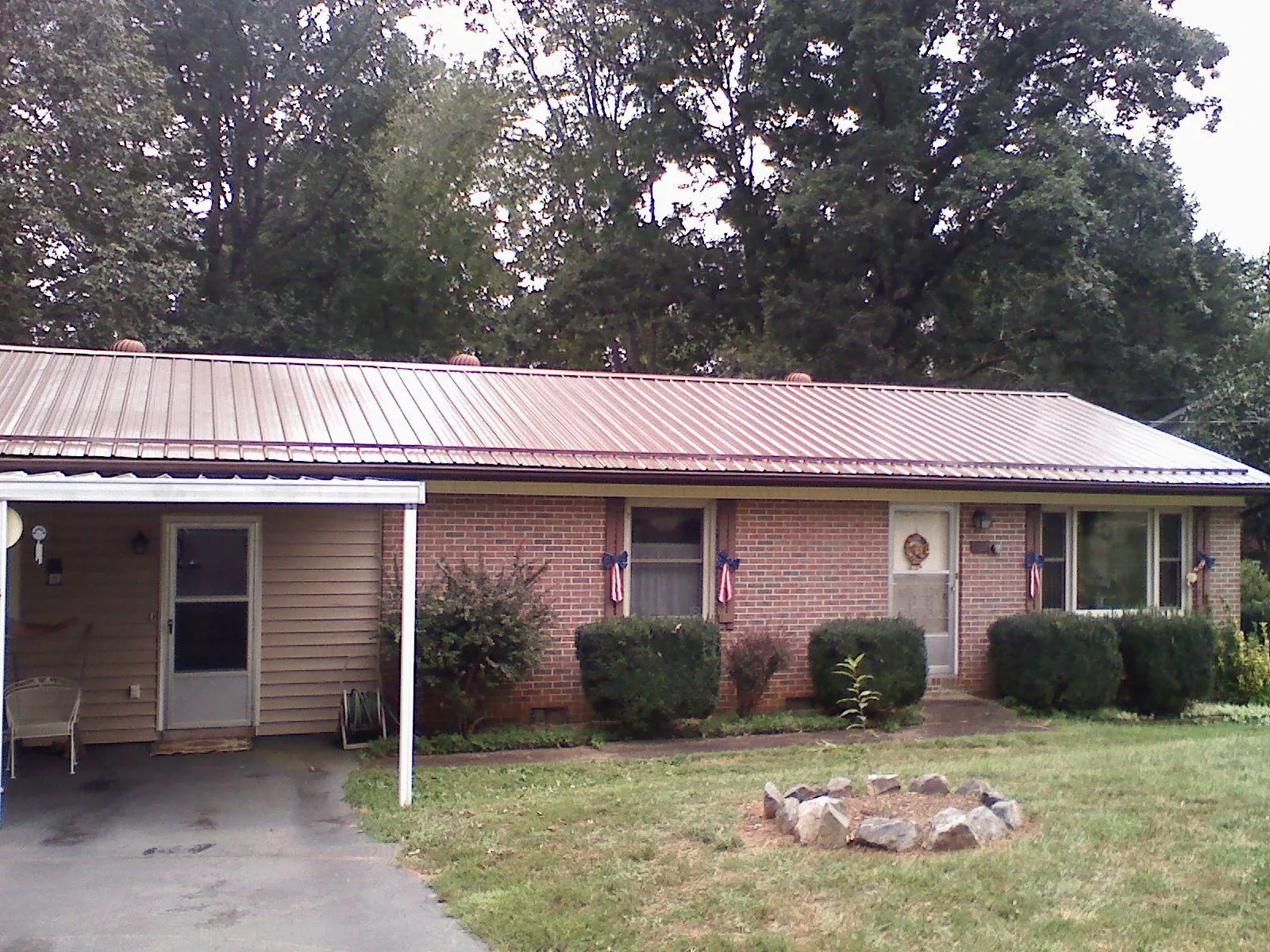 Bronze metal roof and carport on a brick ranch home — Roof Repair work by our crew in Bloomsbury